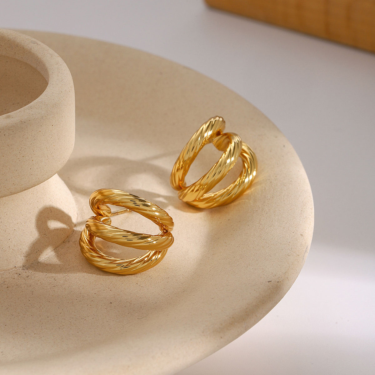 fusion earrings gold steel twist design